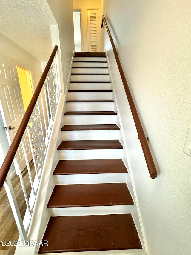 stairs with hardwood / wood-style floors