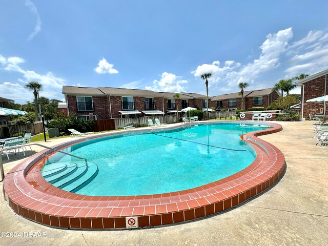 view of swimming pool featuring a patio area