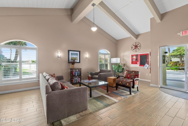 living room with beamed ceiling, plenty of natural light, and high vaulted ceiling