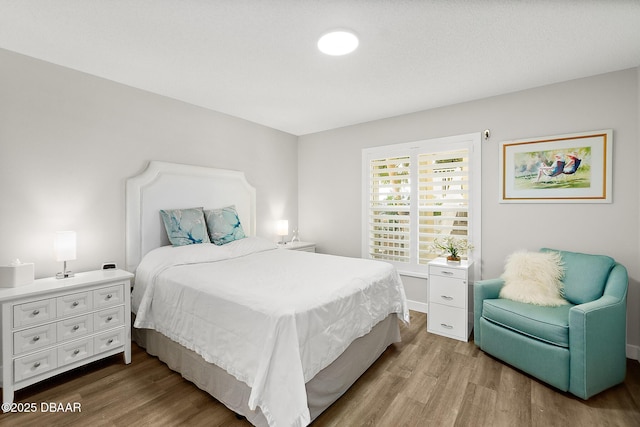 bedroom with wood-type flooring