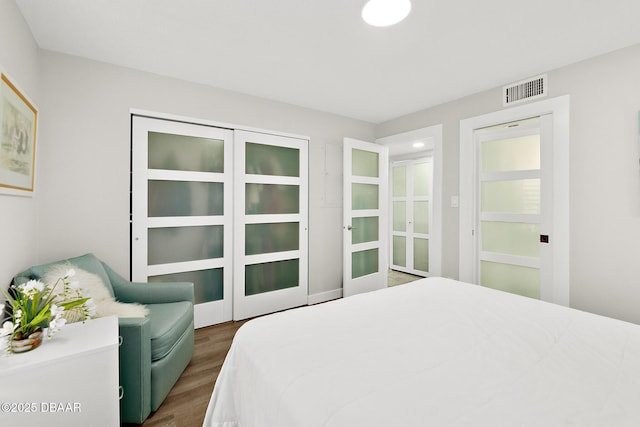 bedroom with dark wood-type flooring