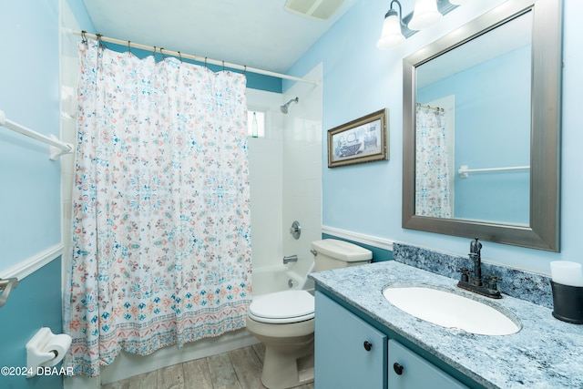 full bathroom featuring toilet, vanity, hardwood / wood-style flooring, and shower / bathtub combination with curtain