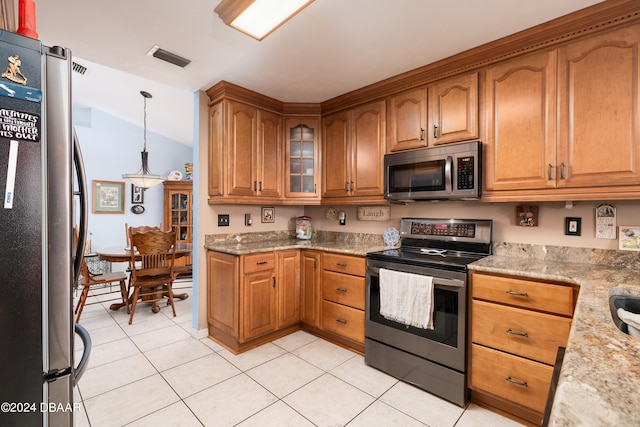 kitchen featuring stainless steel appliances, light tile patterned floors, pendant lighting, light stone countertops, and lofted ceiling