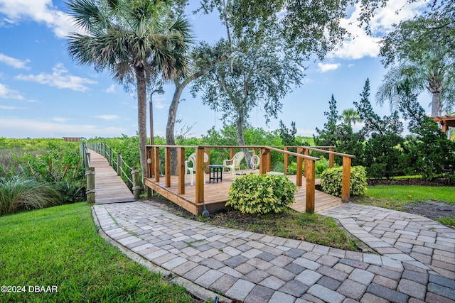 exterior space featuring a deck and a lawn