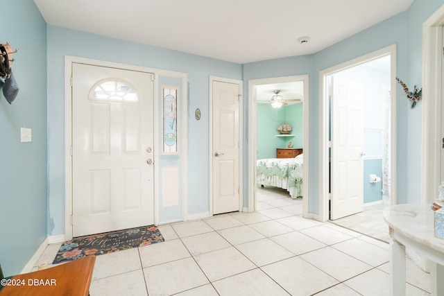 tiled entryway with ceiling fan