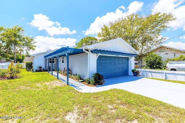 view of front of property featuring a garage and a front lawn