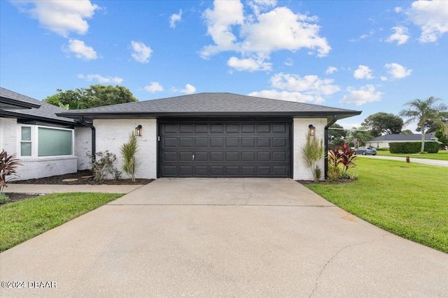 view of front facade with a front lawn and a garage