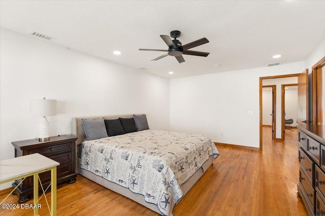 bedroom with light wood-type flooring and ceiling fan