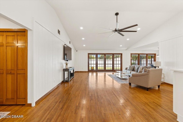 living room with high vaulted ceiling, french doors, ceiling fan, and wood-type flooring