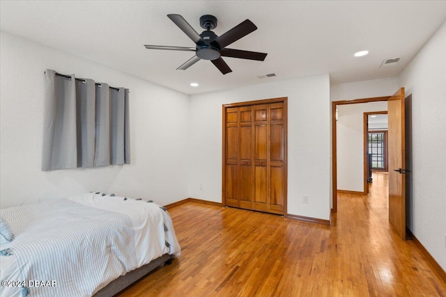 bedroom featuring a closet, ceiling fan, and light hardwood / wood-style flooring