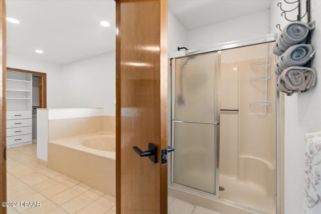 bathroom featuring plus walk in shower and tile patterned flooring