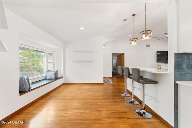 unfurnished living room with vaulted ceiling, ceiling fan, and light hardwood / wood-style flooring