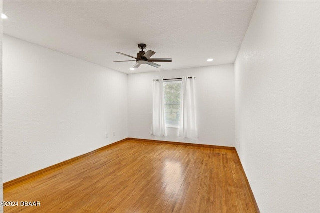 spare room featuring hardwood / wood-style flooring and ceiling fan