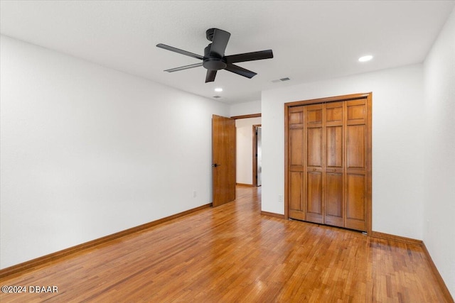 unfurnished bedroom with a closet, ceiling fan, and light hardwood / wood-style flooring