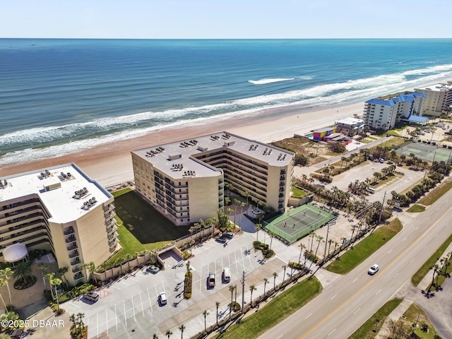 bird's eye view with a water view and a beach view