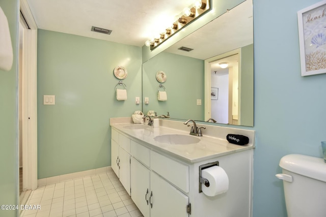 bathroom with tile patterned floors, vanity, and toilet