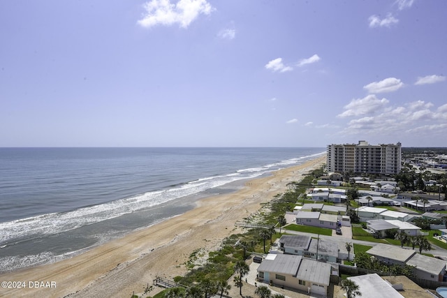 drone / aerial view featuring a water view and a view of the beach