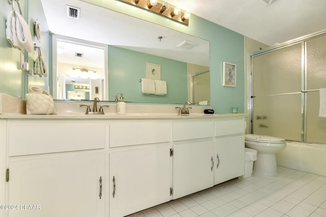 full bathroom featuring tile patterned flooring, vanity, toilet, and bath / shower combo with glass door