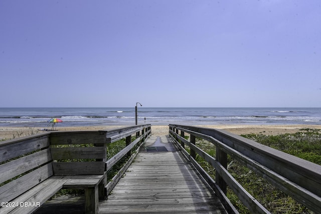 view of home's community featuring a beach view and a water view