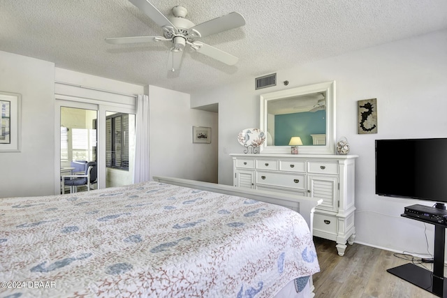 bedroom with access to outside, a textured ceiling, hardwood / wood-style flooring, and ceiling fan