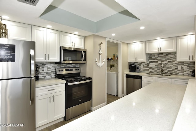 kitchen with white cabinets, appliances with stainless steel finishes, and sink