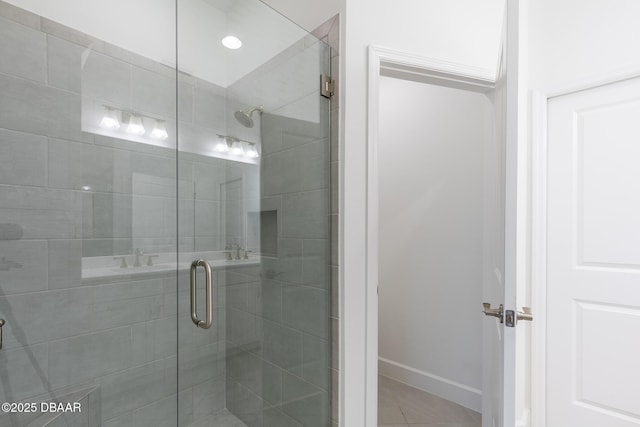 bathroom with tile patterned flooring and a shower with shower door