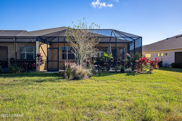 back of house with a lanai and a lawn