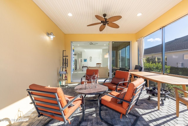 sunroom featuring ceiling fan and wooden ceiling