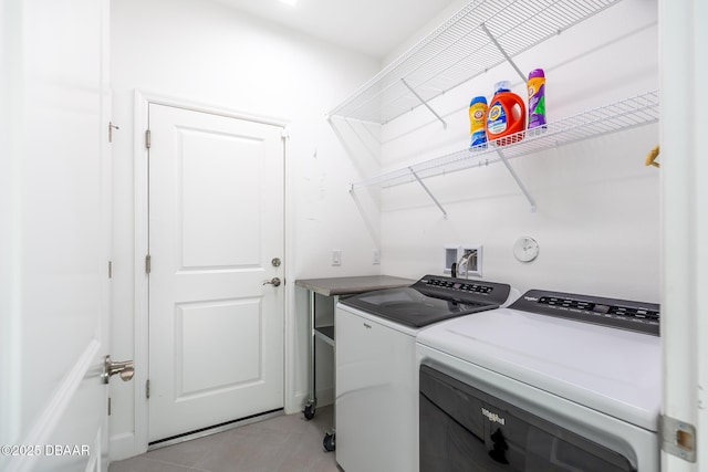 laundry area featuring independent washer and dryer and light tile patterned floors