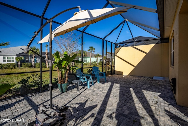 view of patio / terrace featuring a lanai