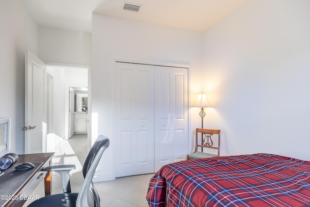 tiled bedroom with a closet