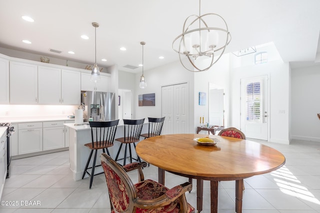 dining room featuring light tile patterned floors and a chandelier