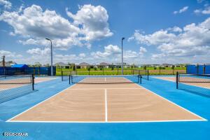 view of tennis court with basketball hoop