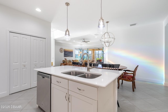 kitchen featuring dishwasher, a center island with sink, sink, ceiling fan, and white cabinetry