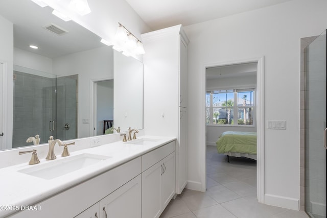 bathroom featuring tile patterned flooring, vanity, and walk in shower