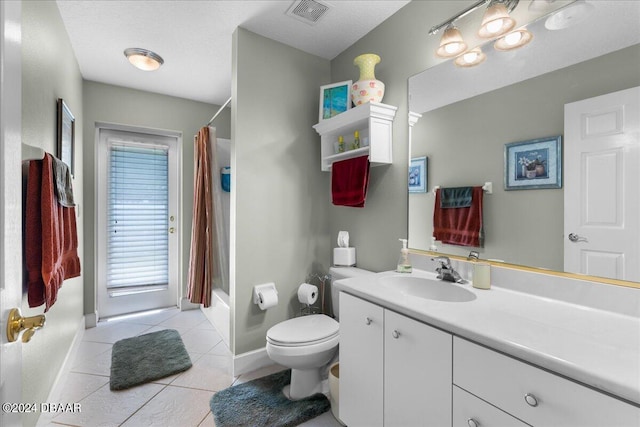 full bathroom with toilet, shower / bath combo, vanity, and tile patterned floors