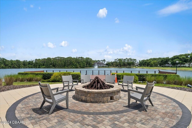 view of patio with a water view and an outdoor fire pit