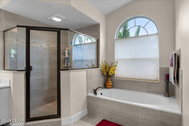 bathroom featuring a textured ceiling and plus walk in shower