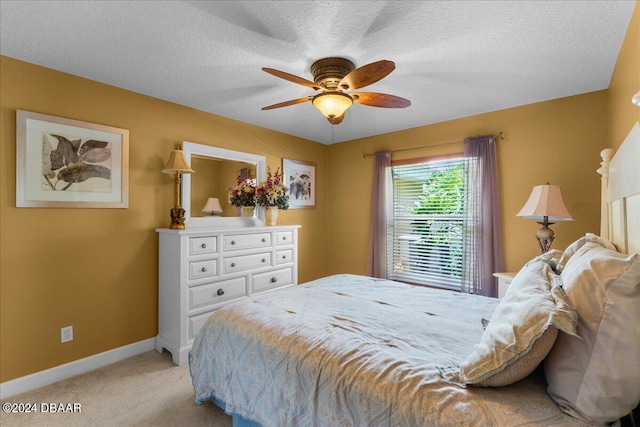 carpeted bedroom featuring a textured ceiling and ceiling fan