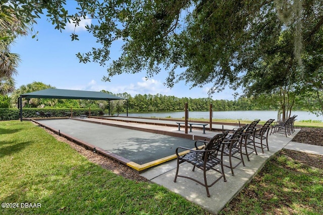 view of home's community featuring a yard and a water view