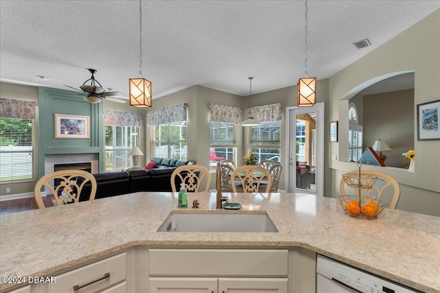 kitchen featuring pendant lighting, a wealth of natural light, and white cabinets