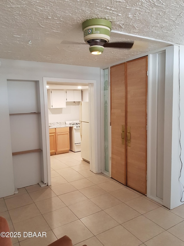 hall featuring light tile patterned floors