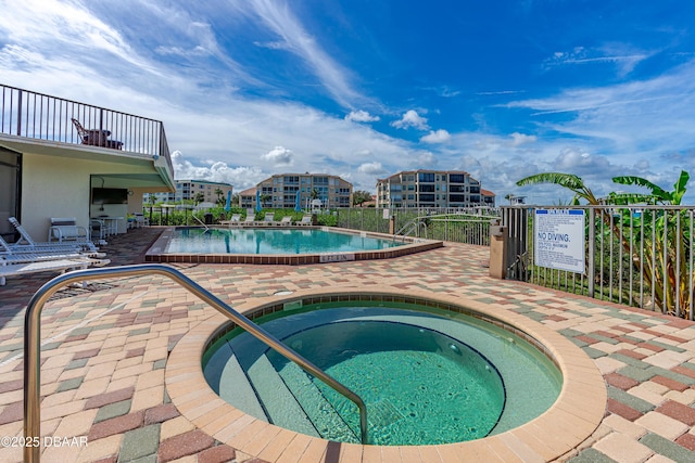 pool featuring a patio and a hot tub