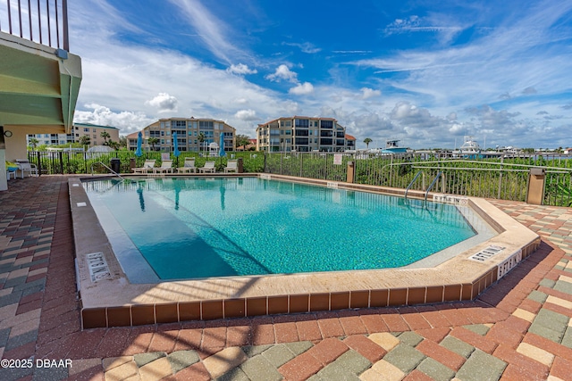 pool with fence and a patio