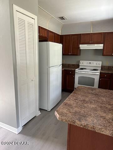 5808 Westport Dr, Port Orange, FL 32127 - kitchen with white appliances, under cabinet range hood, light wood-style floors, and baseboards