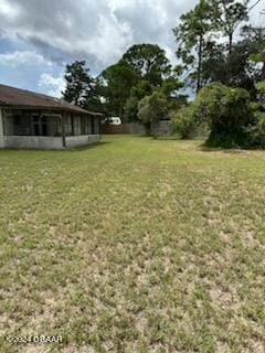 5808 Westport Dr, Port Orange, FL 32127 - view of grassy yard with a sunroom