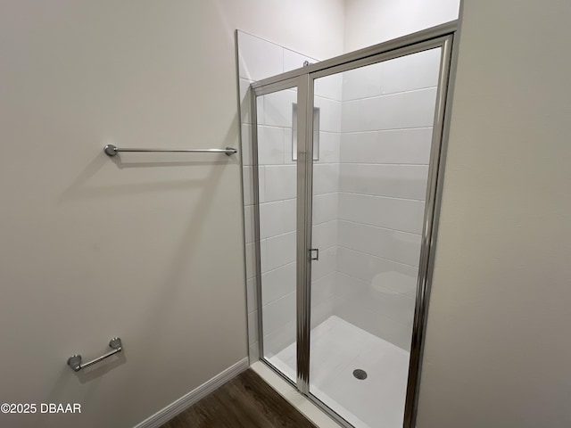 bathroom featuring wood-type flooring and walk in shower