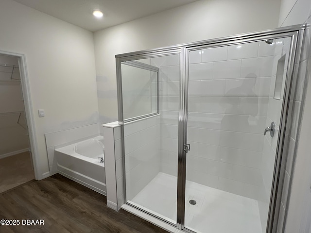 bathroom featuring hardwood / wood-style floors and shower with separate bathtub