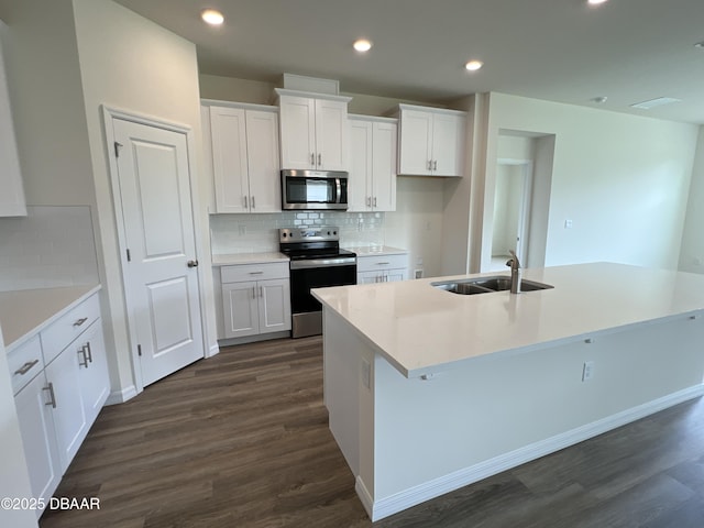 kitchen featuring white cabinets, appliances with stainless steel finishes, and sink