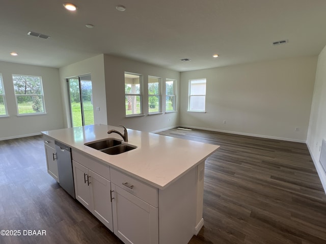 kitchen with dark hardwood / wood-style flooring, sink, a center island with sink, dishwasher, and white cabinetry